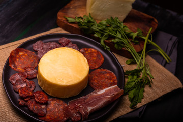 Cheese with serrano ham, olives on a table for a party with friends or as an aperitif
