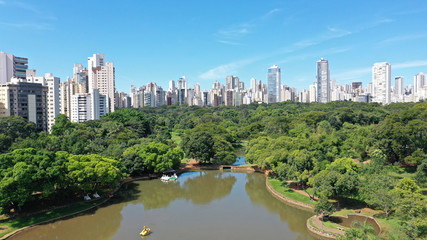 Obraz premium Scenic view of the Zoo in Goiania with several lakes, tropical trees and luxury residential buildings. Goiania, Goias, Brazil 