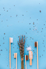 Bamboo wooden toothbrushes Isolated on blue background with lavender, spa aromatherapy oils