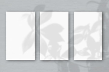 3 vertical sheets of textured white paper on soft gray table background. Mockup overlay with the...