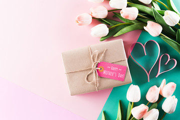 Happy Mother's Day, Women's Day or Valentine's Day greeting concept. Pastel Colours Background with  tulip flowers and gift box ,flat lay patterns.