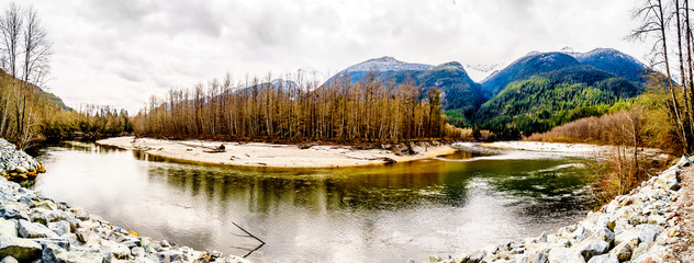 Iron Oxide Stained rocks lining the shore at low water in the Squamish River in the Upper Squamish...