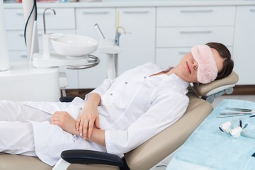 Young doctor asleep on a dentistry seat