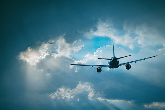 Flying of the passenger plane to the stormy clouds.