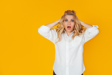 Woman in a panic with her hands clutching her head