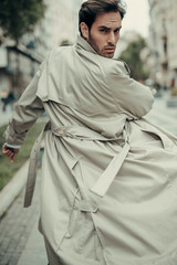Charming young businessman posing on a windy day