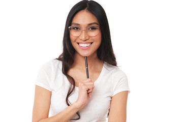 Cheerful asian model in eyeglasses and pen. Beautiful student on white background.