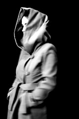 Blurred defocused portrait of a woman in hood.
