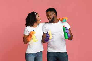 Ready For Cleaning. Happy Black Couple With Household Tools Over Pink Background
