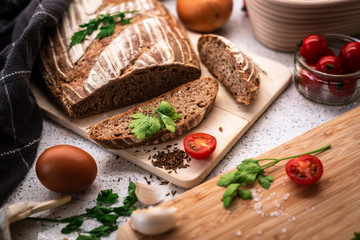 Fototapeta na wymiar Background with bread, rolls, vegetables and herbs