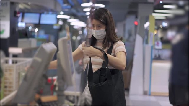 Young Asian Woman In Medical Mask Go Grocery Shopping, At Supermarket Cashier Register Counter, Stocking Up On Foods, Lifestyle During Covid19 Corona Virus, Say No To Plastic Bag, Getting Foods Supply