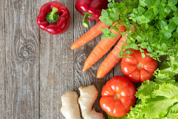 Assorted vegetables on a wooden background. Template for the text.