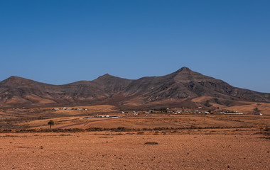 Landscape of fields and mountains near Antigua village, Tefia Windmill, Fuerteventura, Canary Islands, Spain. October 2019