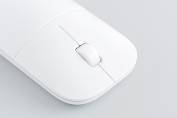 Wireless computer mouse on the gray background.