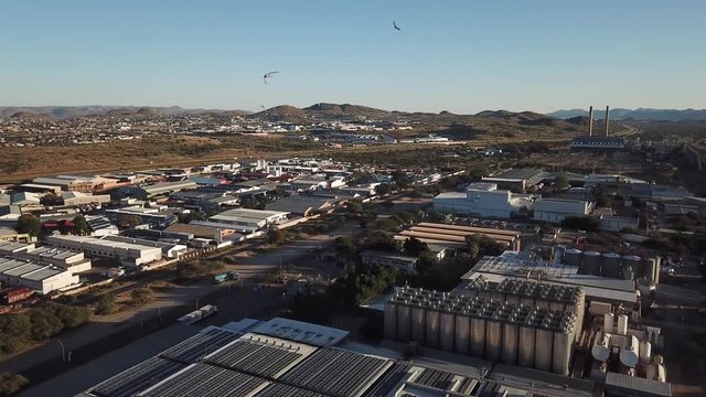4K bright summer morning aerial video of Namibia Brewery beer factory and its hangars located in Windhoek Northern Industrial area, Khomas Region, central Namibia, southern Africa