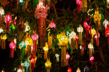 Antique decorative lantern hanging at night with bright and colorful colors.