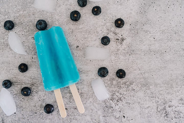 Blue summer popsicle with fresh fruit