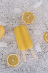 Yellow lemon popsicle with ice