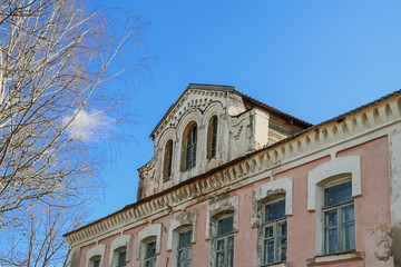 Old abandoned building of the 18th century. Facade of an ancient house.