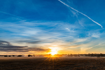 Vast view of rural farming landscape as the sun sets over the land