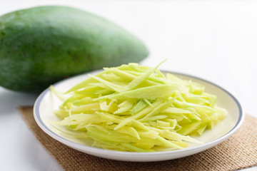 Thai food ingredients, sliced green mango fruit preparing for spicy mango salad (Tum Ma Muang)