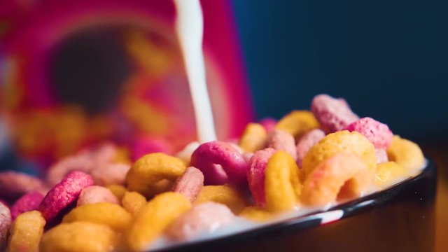 Breakfast Cereals in a bowl with milk in slomotion.