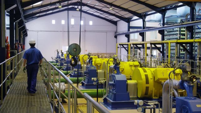 DS WS&nbsp;Worker walking on gangway through compressor hall in water treatment plant