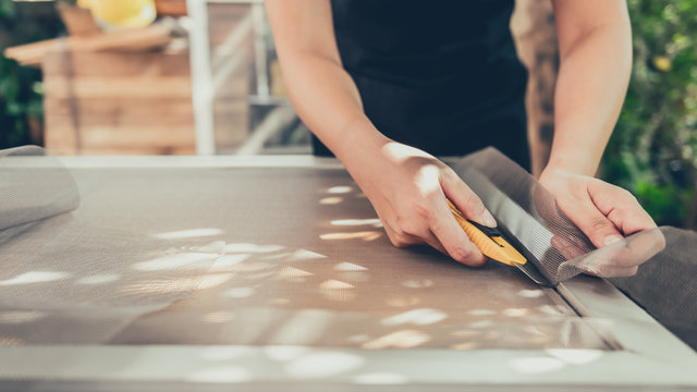 Repair window frame with new mosquito wire screen. Stay home for renovating house. Lifestyle during the Corona virus crisis. Lock down and Self-quarantine at home.