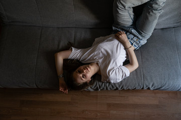 girl lying on a sofa looking at the camera