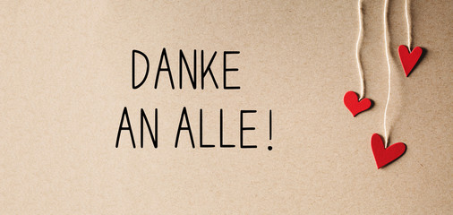 Danke an alle - Thank you all in German language with handmade small paper hearts