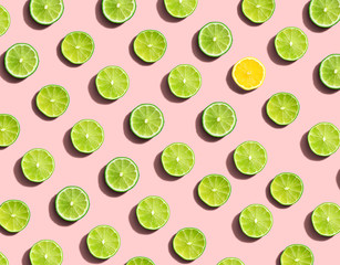One out unique lemon surrounded by limes - flat lay