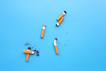 Cigarette butts on blue background.