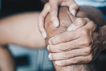 Closeup shot man suffering with knee pain ,Health problems concept	