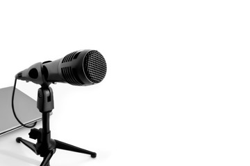 A black microphone isolated on white background. Concept of audio recording or Podcast.