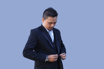 asian business man buttoning suit