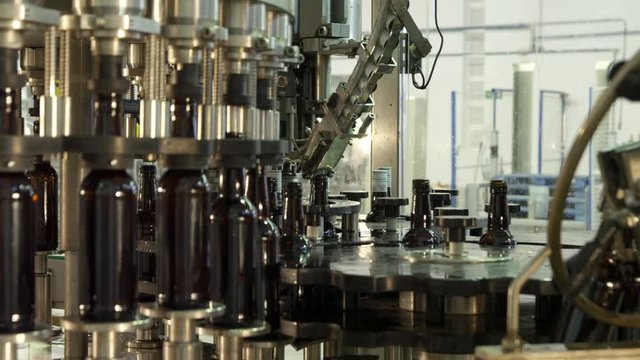 MS Bottles being lifted into filling machine in bottling plant