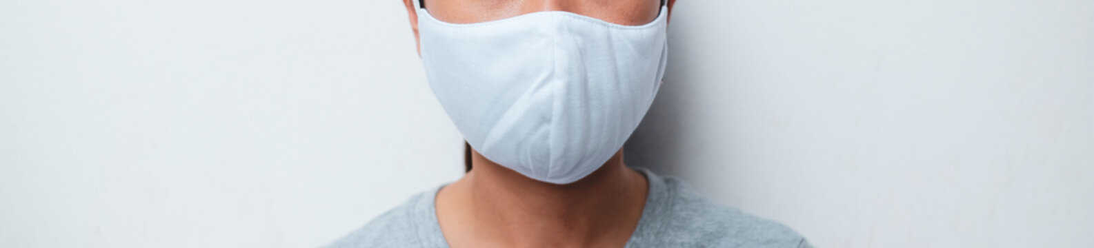 Close up woman portrait, Young woman wearing home made hygienic face medical mask to prevent infection, illness or flu and 2019-nCoV. white  background. Protection against disease, coronavirus.