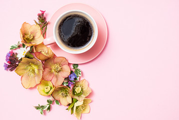 cup of coffee and flowers on the pink background