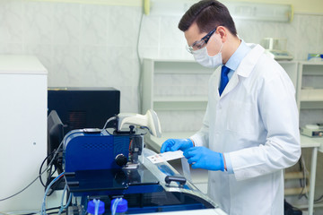 DNA laboratory. The expert puts the human DNA into the database using advanced laboratory technologies