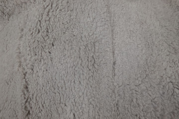 Synthetic fur grey texture for the background. Cream color carpet textures with short hairs fiber natural textile