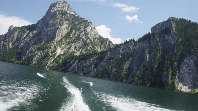 POV&nbsp;WS View from motorboat on lake Traunsee with view of mountains