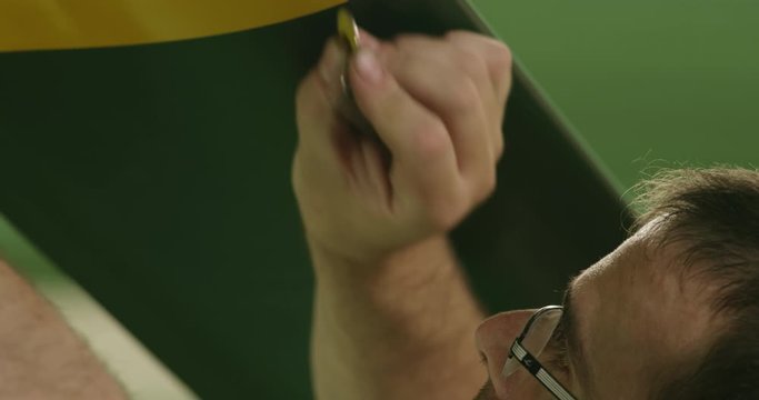 CU Aviation mechanic performing tapping inspection of helicopter rotor blade