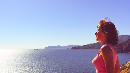Woman enjoy sea breeze.