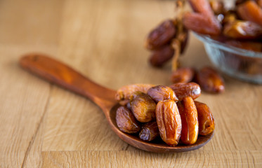 Kurma or dates on wooden background