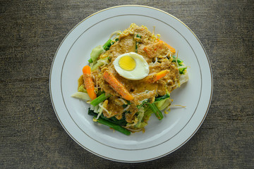 Pecel or pecel sayur, indonesian traditional food made from various boiled vegetables such as carrots, bean sprouts, cabbage and other vegetables and then given with peanut sauce. healthy food