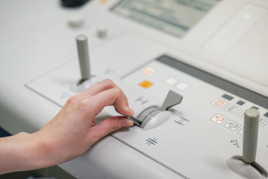 Radiologist female hand operating  Fluoroscopy machine while patient case, Medical concept - Powered by Adobe