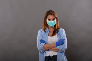 Woman wearing protective mask and gloves against pandemic virus in studio shoot