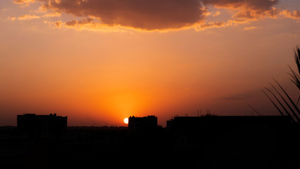 Fototapeta na wymiar a sunset in city buildings silhouette