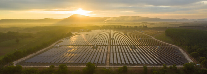 Aerial view of the solar panel with a sunny sky at sunrise.  Concept of clean energy conservation....