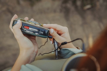 An old cassette player is in girl's hands